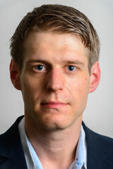 Obraz premium Portrait of young handsome businessman in suit with blond hair