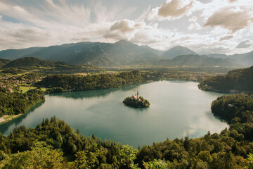 Obraz premium Beautiful view on lake Bled in Slovenia. Lake Bled in the morning sun. Sunrise on lake Bled. Nature, mountain scenery with a small church