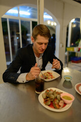 Young handsome businessman at the restaurant indoors