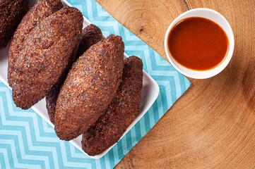 .Kibe Fried. Very typical in Brazil. Accompanied by lemon and pepper sauce. Top view