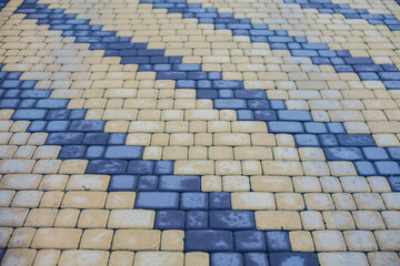 Nested pavers of various colors, around the grass is green, chic garden