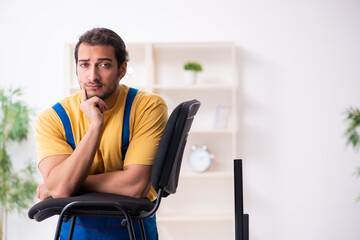 Young male carpenter working indoors