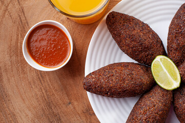 .Kibe Fried. Very typical in Brazil. Accompanied by lemon and pepper sauce. Top view