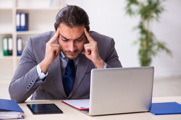 Young businessman employee sitting in the office