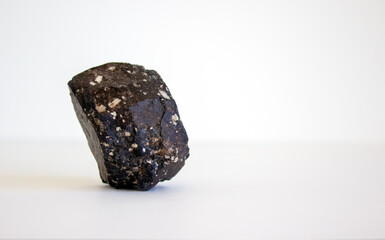 Concept image. Volcanic rock isolated on beautiful white background. Web banner with a copy space.
