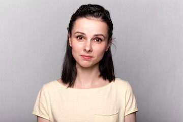 lovely girl in a yellow t-shirt on a gray background