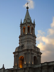 Fototapeta na wymiar Bell tower of Arequipa Cathedral during sunset. The cathedral is located on Arequipas main square.