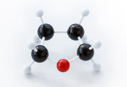 Plastic ball-and-stick model of a tetrahydrofuran (THF) molecule on a white background. Tetrahydrofuran is an example of a heterocyclic compound.