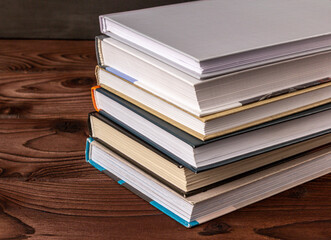 High angle close up of stack of books on wooden table. Books in the library on the table....