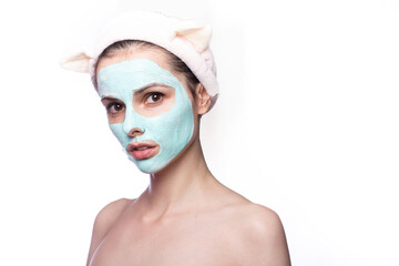 woman in a cosmetic mask on her face  in a funny headband