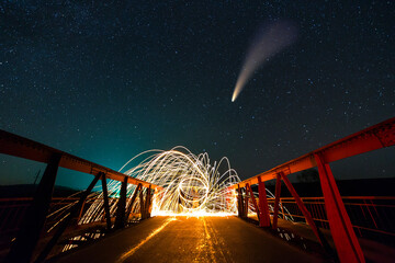 Long exposure of spinning steel wool in abstract circle making firework showers of yellow glowing...