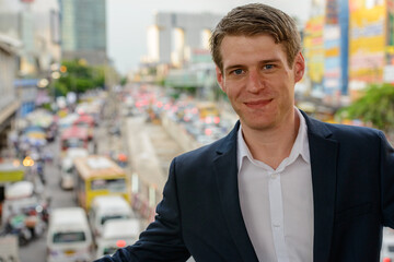 Young handsome businessman in the city streets outdoors