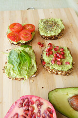 Delicious and healthy guacamole sandwiches on a bamboo board 