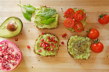 Guacamole sandwiches on wooden board