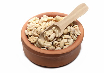 Pile salted and marinated peanuts in clay pot isolated on white background