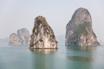 Fototapeta premium Ha Long Bay, Vietnam, towering limestone islands topped by rainforests, 