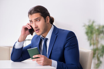 Young businessman holding passport preparing for trip