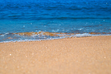 Soft waves on sandy beach. Macro photography