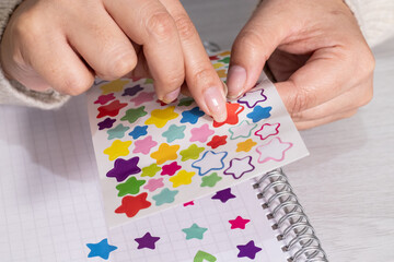 placing stickers in a note book