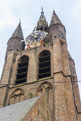 Fototapeta na wymiar Old Church (Oude Kerk, was founded in 1246) is a Gothic Protestant church in Delft, Netherlands. Its most recognizable feature is a 75-meter-high brick tower that leans about two meters from vertical.