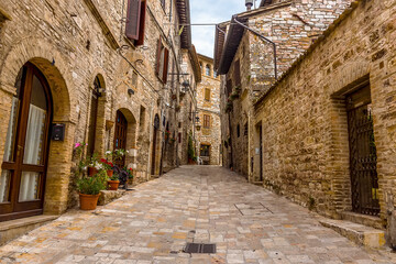 Fototapeta na wymiar A view up a street leading up Mount Subasio in Assisi, Umbria in the summertime