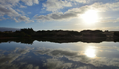Awesome sunrise with beautiful reflections in the water, Charca de Maspalomas, Canary Islands, Spain
