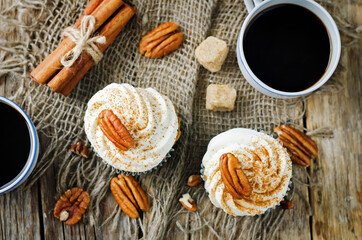 Carrot cinnamon cupcakes with cream cheese and pecan nuts