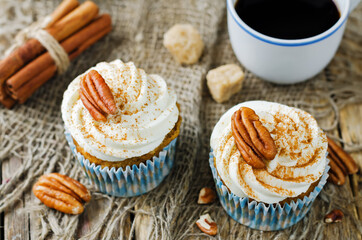 Carrot cinnamon cupcakes with cream cheese and pecan nuts
