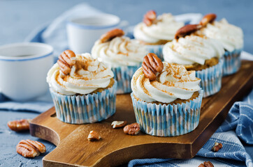 Carrot cinnamon cupcakes with cream cheese and pecan nuts