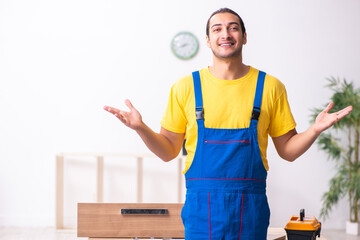 Young male carpenter working indoors