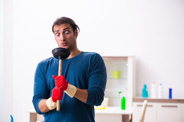 Young man husband doing plumbing at home