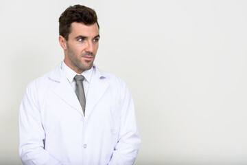 Portrait of handsome Hispanic man doctor thinking