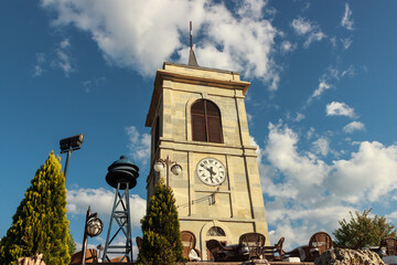 Historical stone clock tower with cloudy blue sky landscape in Kastamonu, Turkey.