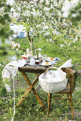 Details of a rustic wedding table with cake, strawberries, flowers and sweet elements