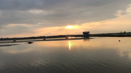 sunset evening with clouds over the river