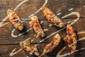 Cream Cheese Filled Bacon Wrapped Jalapeno Poppers On Wood Background
