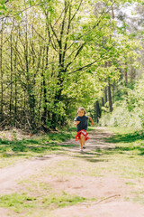Girl running on trail in forest