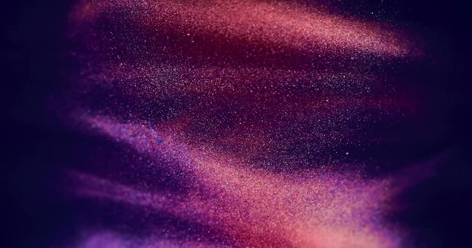 Amazing purple golden orange glitter paint creating abstract clouds background texture. Beautiful blue and pink vibrant color fluid is swirling in art background. Beautiful shimmer moving in water