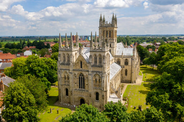 Fototapeta na wymiar Selby Abbey North Yorkshire England. Drone photograph of the Abbey looking at the south and east side in sun with Selby town behind. 