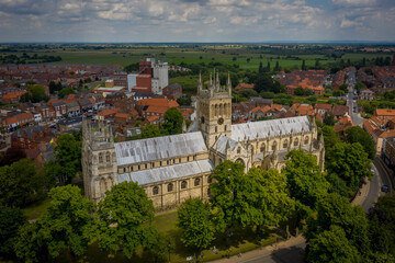 Fototapeta na wymiar Selby Abbey North Yorkshire England. Drone photograph of the Abbey looking at the south side in sun with Selby town behind. 