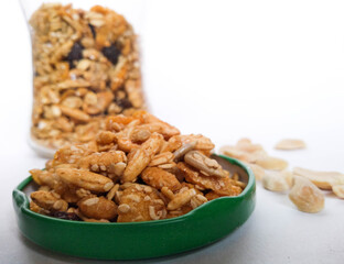 Granola in green bowl with white background