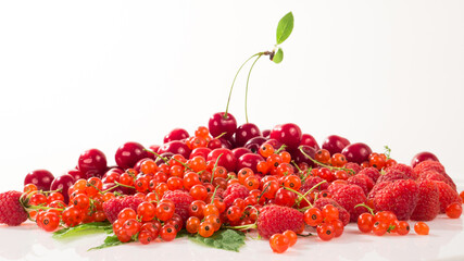 Assorted berry on a white background. Cherries, raspberries, red currants.