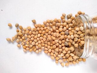 Chickpeas in glass fresaco on white background