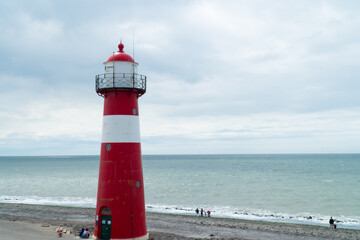 Fototapeta premium Lighthouse near a rock beach overlooking the NorthSea, shot in Westkapelle 
