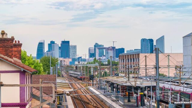 4k timelapse of skyscrapers of Paris business district La Defense on a cloudy summer day and the RER train station. From houilles, west of Paris, France.Camera zooms out