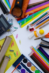 Colorful school supplies on white surface with copy space,Able to use vertical or horizontal way. 