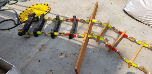 picture of a marine ladder used to usually embark on board boats while they are at sea,also called...