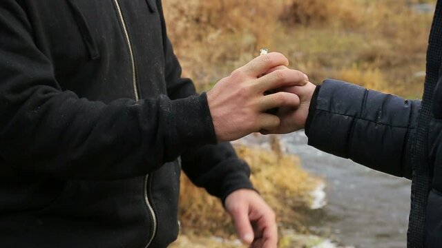The man tries, attempts to take away, grab the grenade, but it falls down - Slow Motion