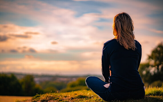 Young Woman Watching At Sunset