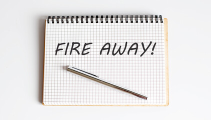 FIRE AWAY text written on a notebook with pen